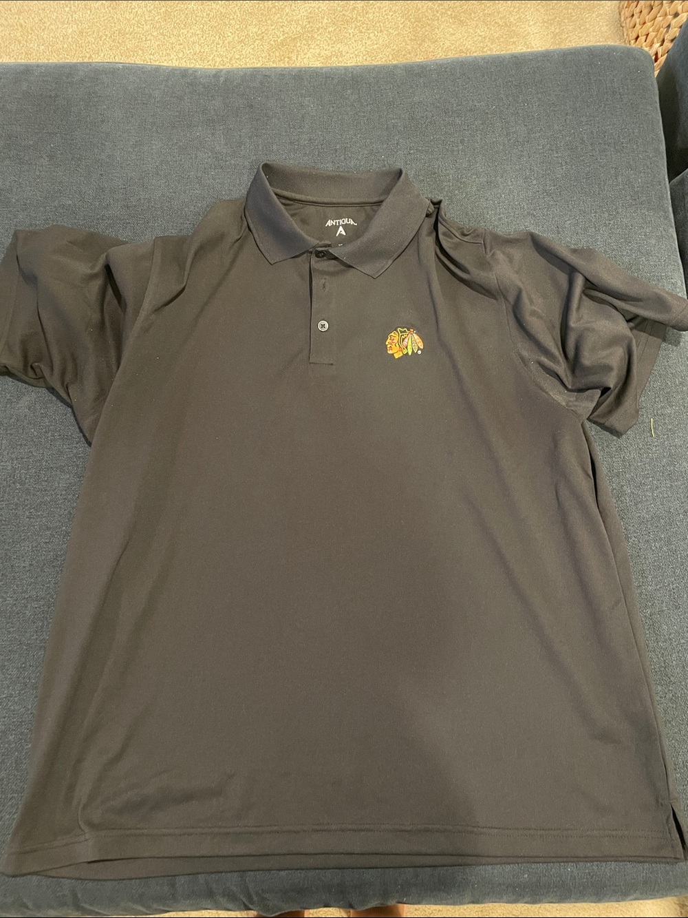 Antigua Black Polo with Chicago Blackhawks Embroidered Logo